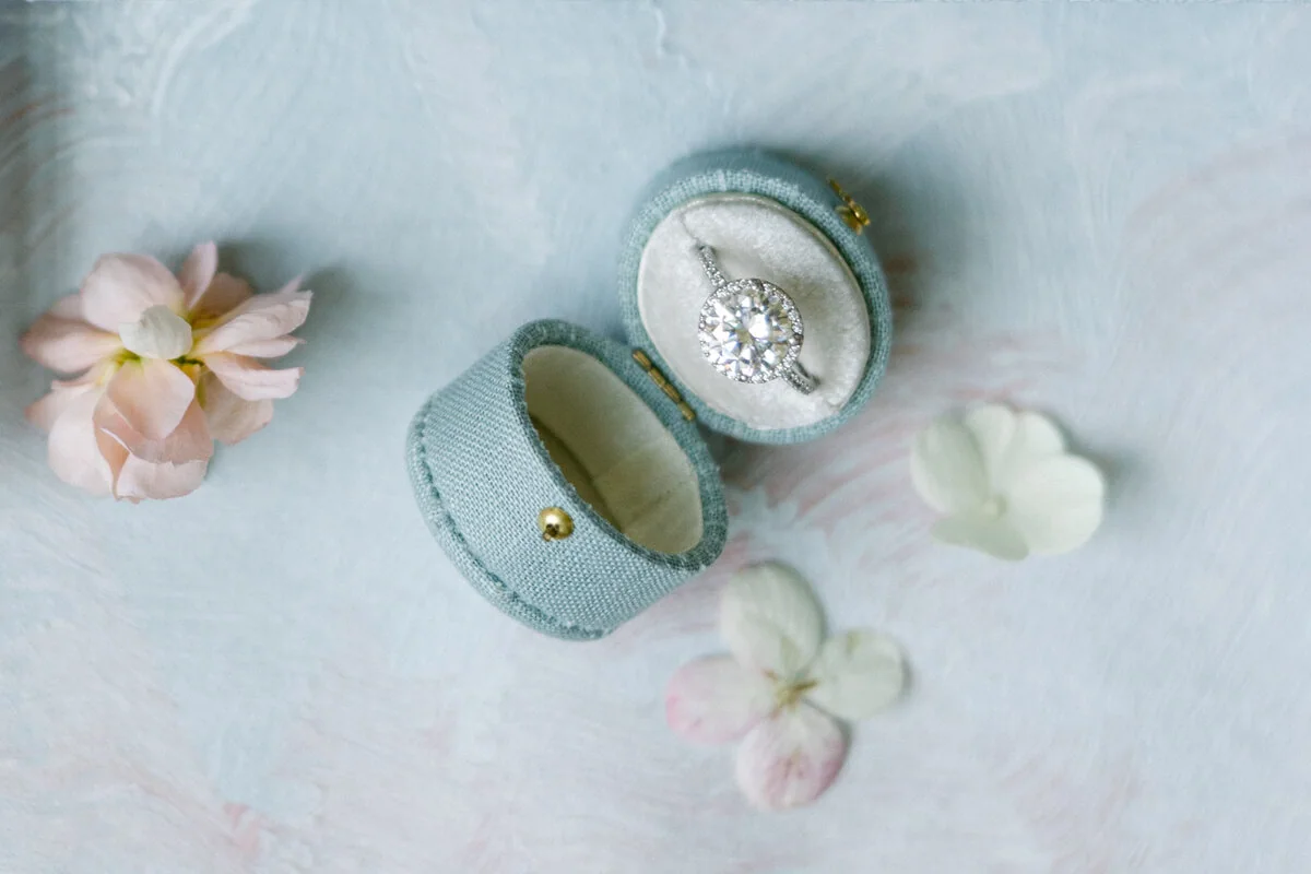Engagement rings arranged with soft flowers and delicate details