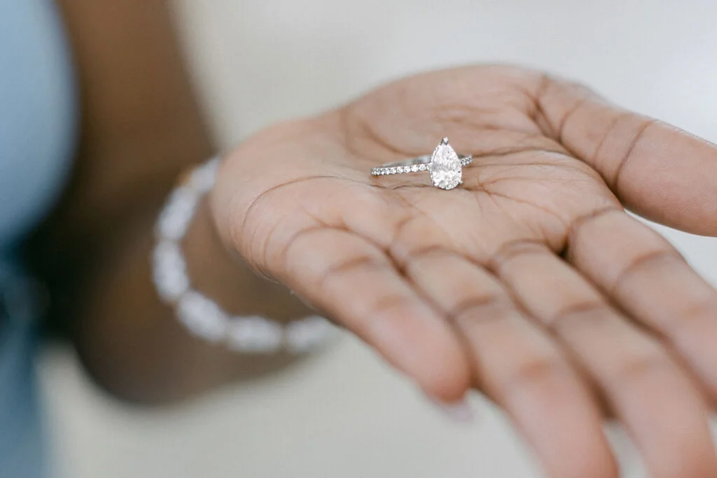 Diamond engagement ring displayed in an open hand