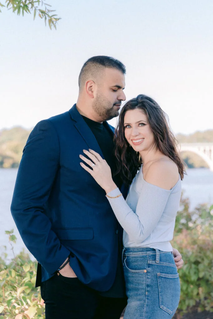 Engaged couple standing together during a waterfront portrait session