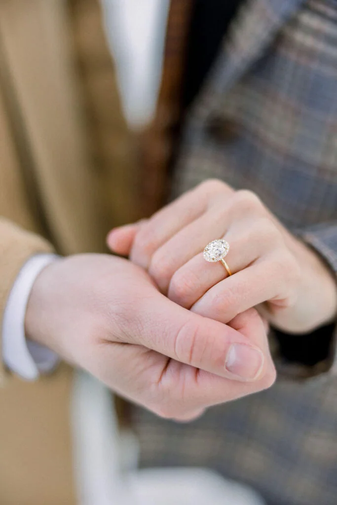 Engagement ring presented in a person’s hands