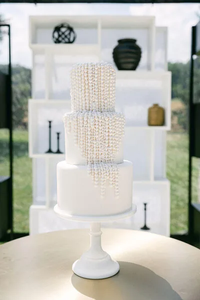 White wedding cake adorned with delicate pearls