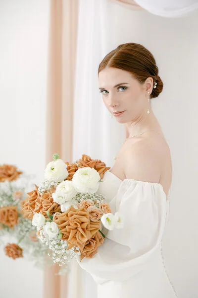 Bride holding an exquisite white floral bouquet