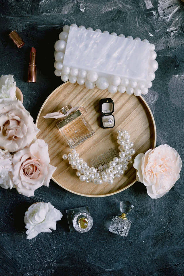 Flat lays — white purse, necklace, and earrings