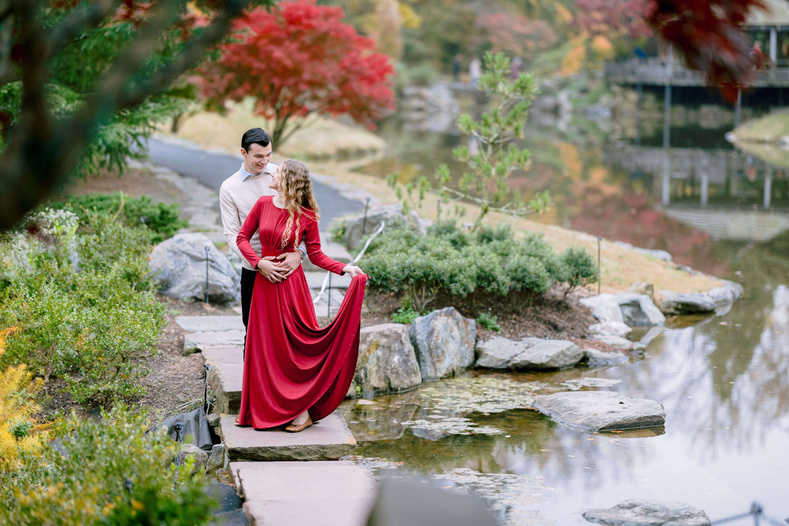 Romantic Engagement Sessions in Fall at Brookside Gardens, Maryland - Couple in Red Wine Dress and Beige Sweater Poses