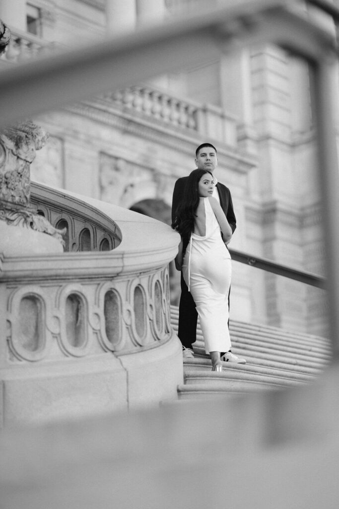 An intimate portrait by Get Ready Photo, featuring a couple closely embraced, with the man's hands gently around the woman's waist. This wedding and engagement photographer from Washington DC highlights the couple's anticipation and connection in a timeless black and white image.
